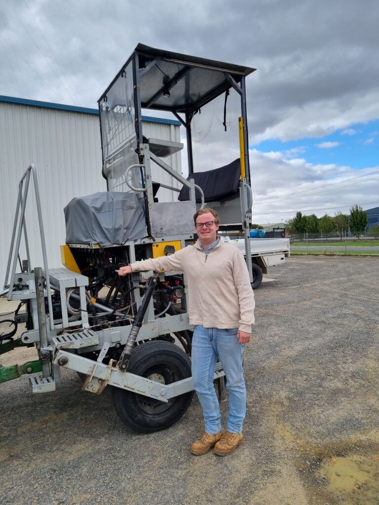 Business Manager James Murray in front of a seeder