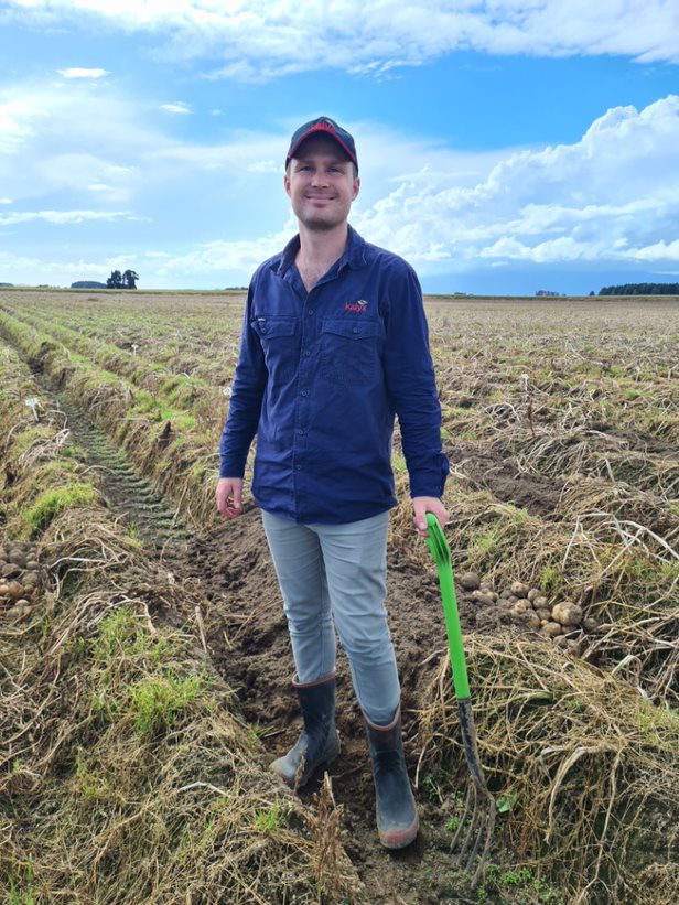 Jarrod Harvey in the field harvesting potatoes